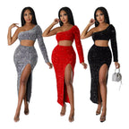 Three women wearing sparkly one-shoulder dresses in silver, red, and black.