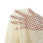 Close-up of a cream-colored open-knit mesh fabric draped to show its texture and pattern against a white background.