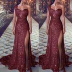 Red sequin evening gown with a high slit on a patterned floor.