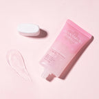 Pink skincare product with a white container on a pink background