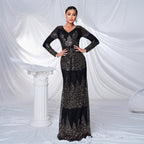 Woman wearing a black and gold sequin dress against a white draped curtain background