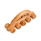 Wooden massage roller on a gray textured background