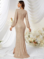 Woman wearing a sparkly gold evening gown in a decorated indoor setting with white curtains and floral arrangements.
