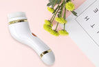 White electronic device with gold accents on a pink surface with yellow flowers.