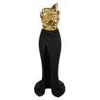 Black gown with gold headpiece on a white background