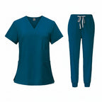 Teal medical uniform set with top and pants on a white background