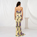 Woman wearing a floral dress with a white curtain background