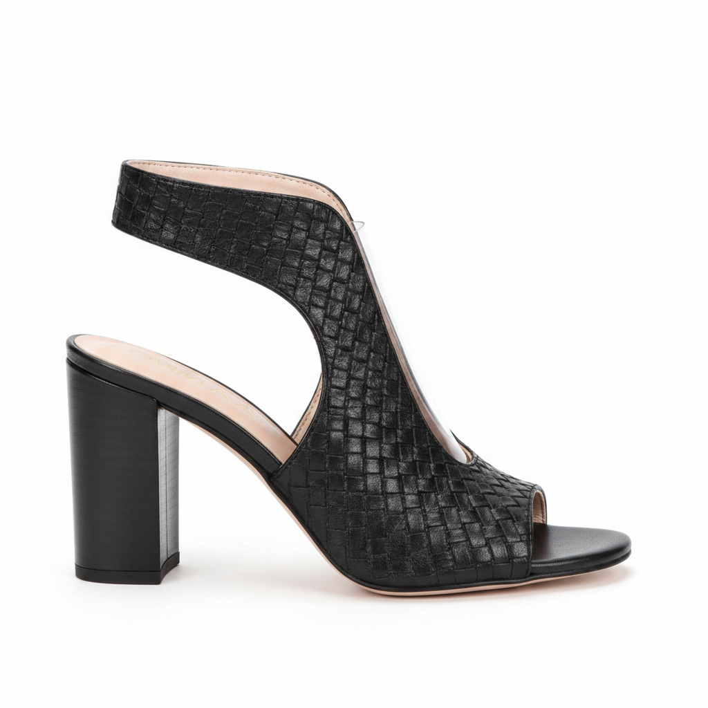 Black woven-texture slingback high-heeled sandals with cutout peep toes, shown being worn and held by a hand against a plain beige background.
