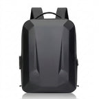 A matte black backpack with a geometric, faceted design, shown from the front on a white background with a subtle reflection.