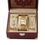 A luxury jewelry and watch gift set displayed inside an open burgundy faux-leather presentation box with gold trim and a beige velvet interior. The set includes a gold-tone rectangular watch with a gold link bracelet, diamond-studded necklaces, rings, and earrings.