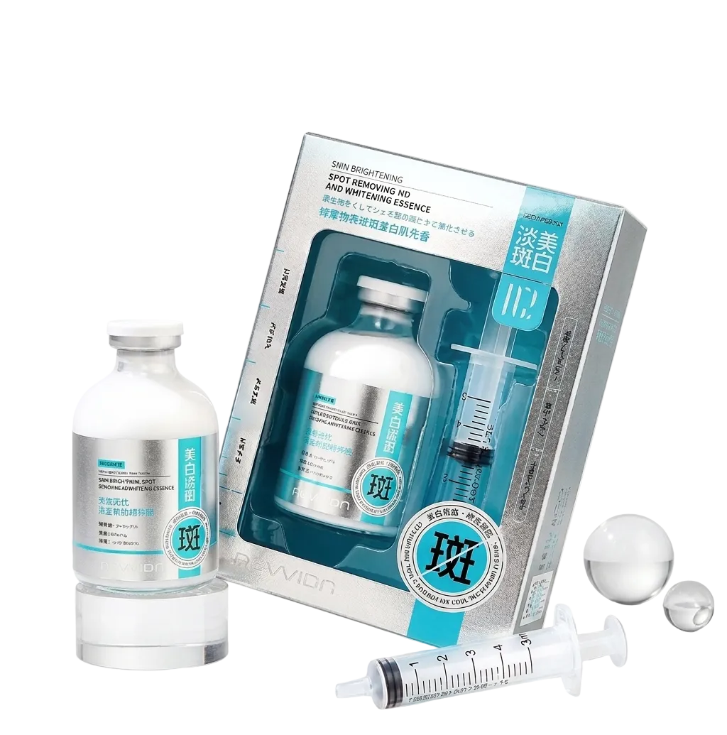 A skincare set displayed on a clean white studio background, including a boxed vial of spot-remedying no. 1 serum essence, a separate white bottle, a syringe, two clear gel spheres, and printed packaging with blue, white, and silver tones.