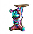 A glossy, iridescent bear-shaped candle holder or pedestal base with a gold-toned circular tray on its head, set against a plain white background.
