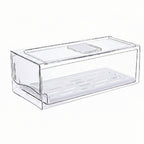 A clear plastic drawer organizer box with a slotted bottom tray, shown on a plain white background.