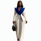 A woman modeling a two-piece cream and royal blue tailored suit with a structured peplum-style top and wide-leg trousers, shown against a plain white background.