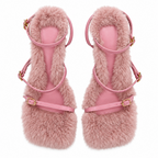 A pair of pink fuzzy platform sandals with thin pink straps and gold-tone buckle details, shown from a top-down view on a white background.