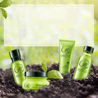 Four Green Tea Care products from the brand 'Green Tea' are arranged on dark soil with green leaves against a soft, blurred green background. The products include a bottle, a jar, and a tube, all in a vibrant green color with black lids and white branding.