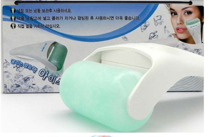 White and green facial cleansing device with packaging in the background