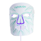 A LightActim facial LED therapy mask on a white background, featuring a white faceplate with light green leaf line patterns and a purple nose cutout.
