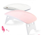 Pink and white electronic device on a white background