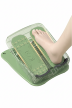 Green foot massager device with a foot placed on it against a light green background