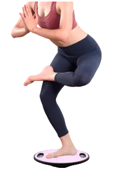 Person using a balance board for exercise on a wooden floor.