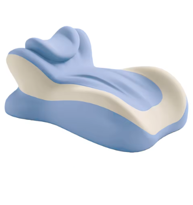 A contoured lumbar support pillow in light blue and cream, shown alongside a woman lying down using a smartphone on a white background.