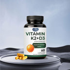 Vitamin K2+D3 supplement bottle with capsules on a gray surface