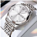 A silver-tone stainless steel watch with a white dial and matching metal link bracelet, displayed on a white cushion. The brand name 'OLEVS' is visible in a red logo box in the top-left corner.