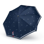 Navy blue umbrella with sailboat pattern on a white background