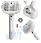 White handheld pet grooming brush shown from multiple angles on a white background, with a USB-C charging cable and a play icon in the center.