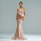 Elegant evening gown with floral details on a plain background