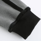Close-up of gray pants with black ribbed cuffs on a white background