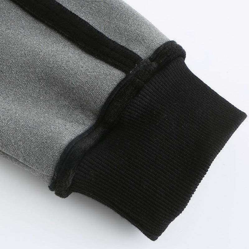Close-up of gray pants with black ribbed cuffs on a white background