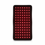 Red light therapy mat with UK plug, power adapter, and instructional manual on a white background.