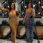 Two women in elegant evening gowns standing in a stylish interior setting.