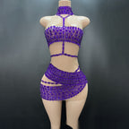 Mannequin wearing a purple beaded two-piece outfit against a dark background