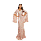 Woman in a pink evening gown standing on a staircase