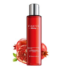 Red skincare bottle with pomegranate graphics on a white background