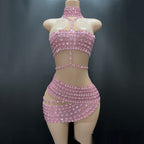 Pink beaded two-piece outfit on a mannequin against a dark background