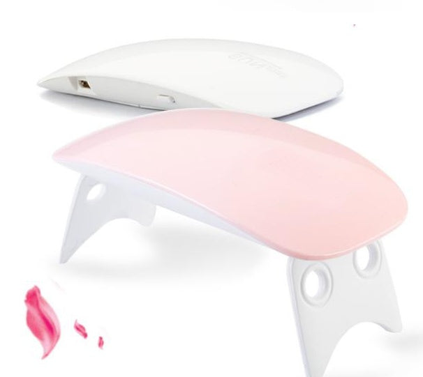 White and pink electronic device on a white background