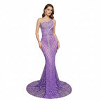 Purple evening gown on a mannequin against a decorative wall.