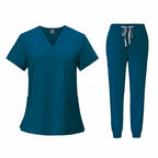 Teal medical uniform set with top and pants on a white background