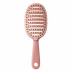 Pink paddle hair brush with packaging on a white background