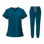 Teal medical uniform set with top and pants on a white background