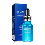A blue glass dropper bottle of hyaluronic acid essence featuring a dropper against a dark background.