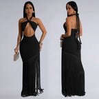 Black fringe dress worn by a model on a plain background