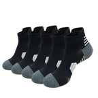 Set of five pairs of black socks with gray toes and heels on a white background