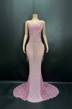 Pink beaded evening gown on a mannequin against a dark background