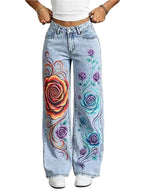 Light wash blue wide-leg jeans with colorful hand-painted style rose designs on the front of both legs, shown on a model from the waist down.