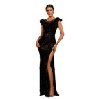 Black sequin evening gown with a high slit on a white background